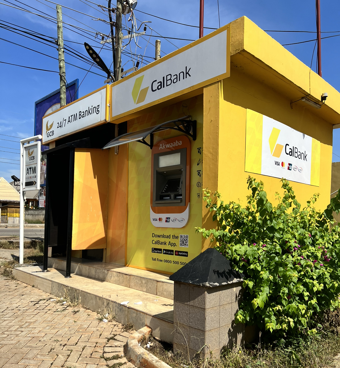 A picture of a bright yellow CalBank ATM stand 