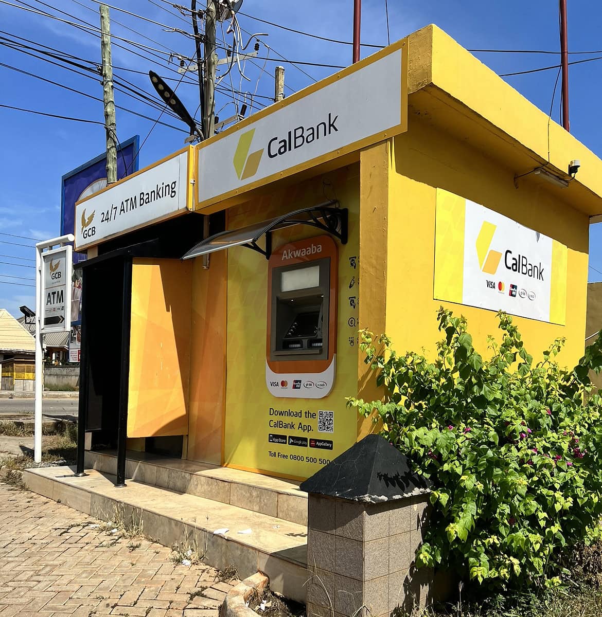 A picture of a bright yellow CalBank ATM stand