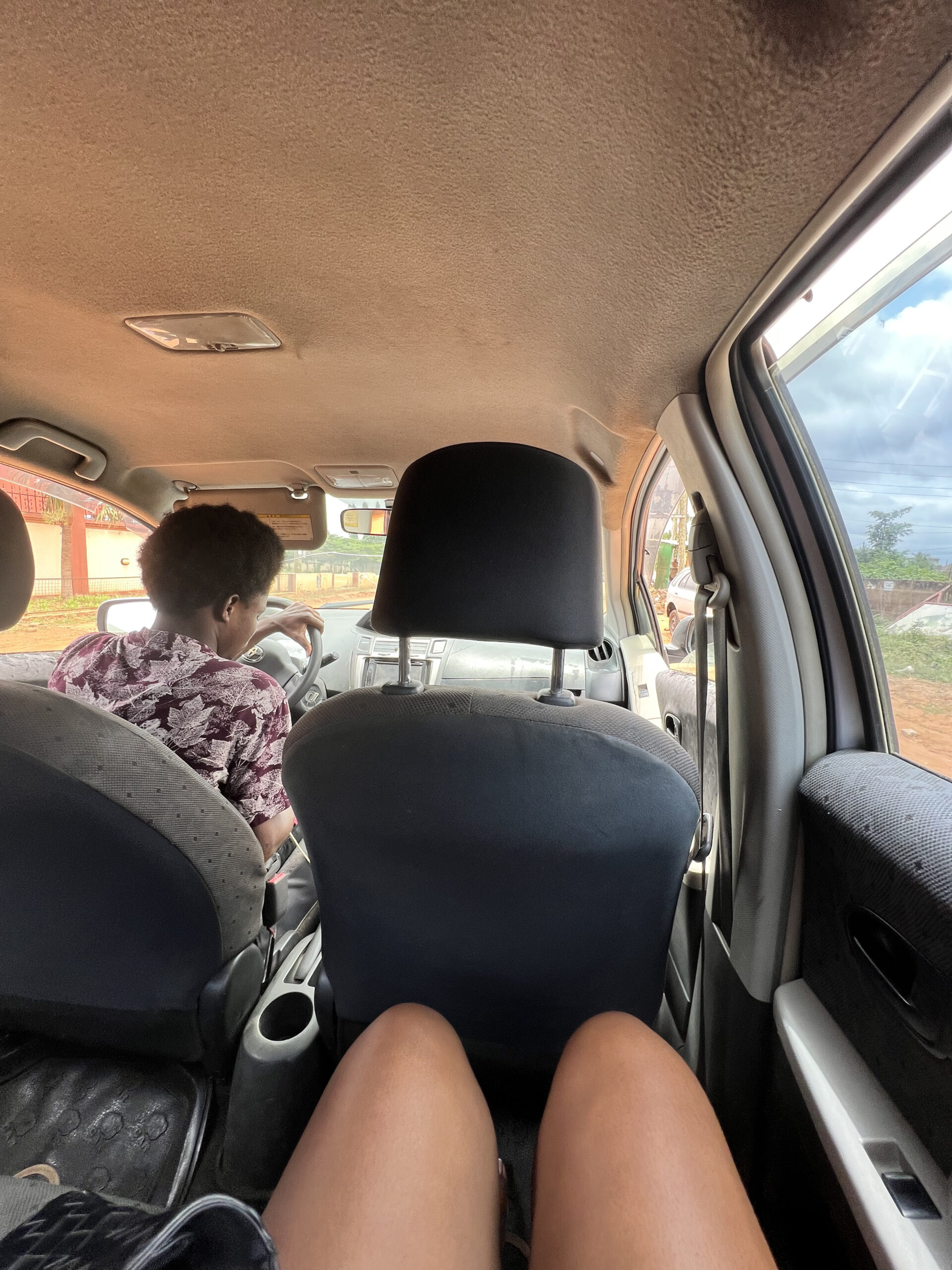 An image of legs in the back of an Uber. 