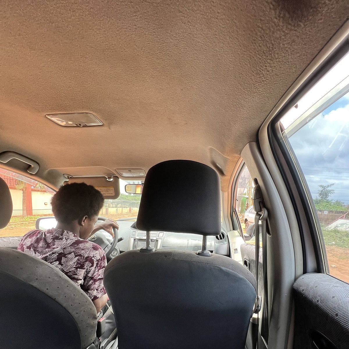 An image of legs in the back of an Uber.