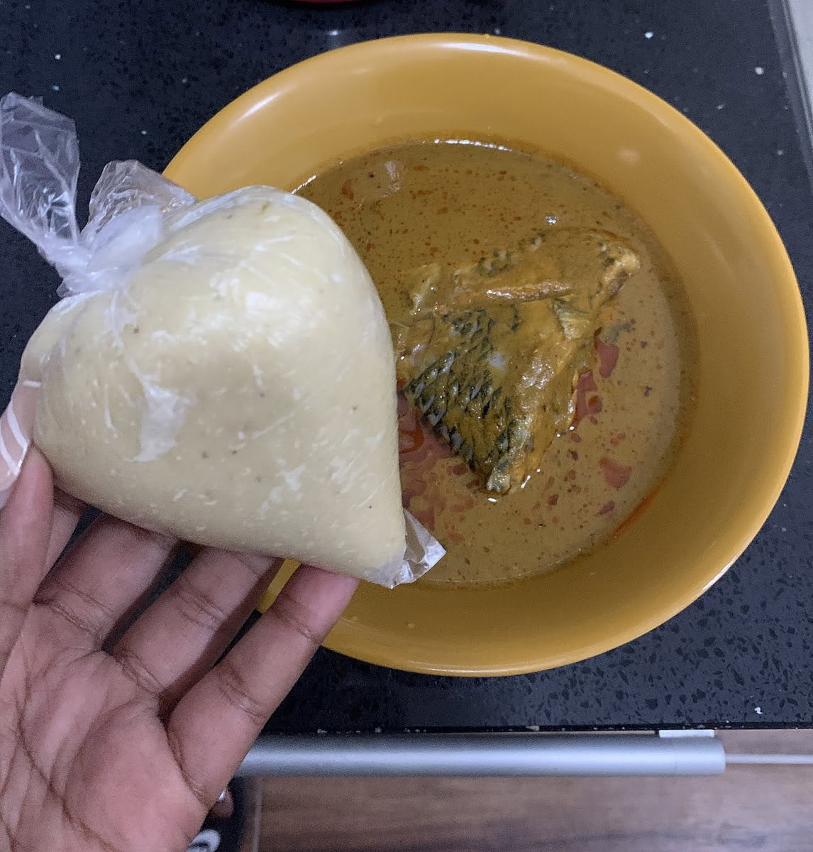 A bowl of groundnut soup with banku.