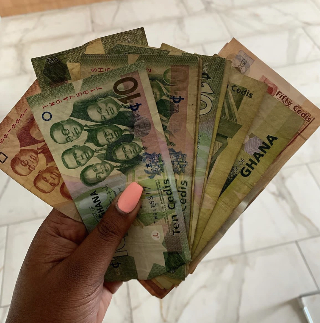 A variety of Ghanaian cedi bills spread out