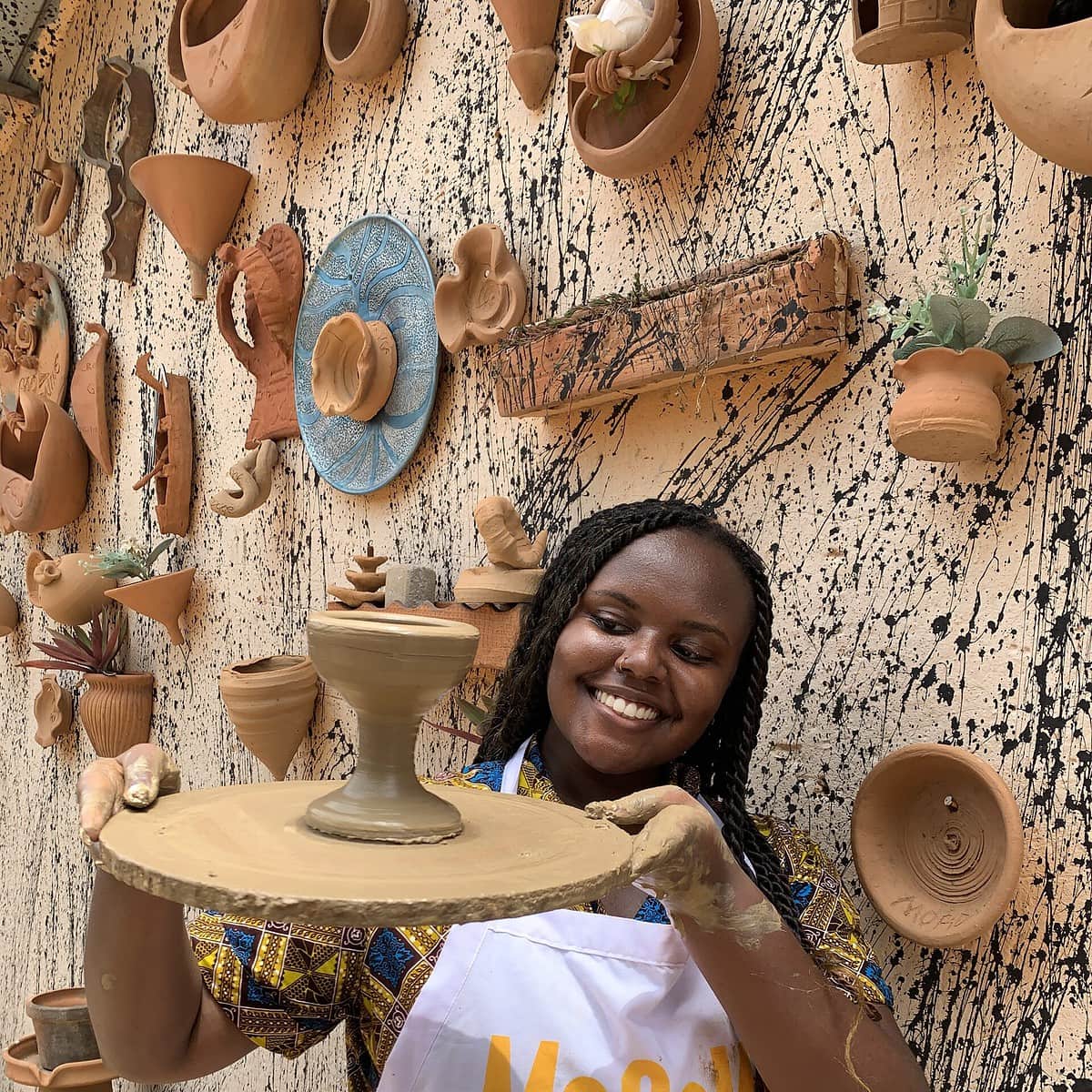 Blogger Christina Jane holding a wine glass she made on a Mooove Africa day trip.