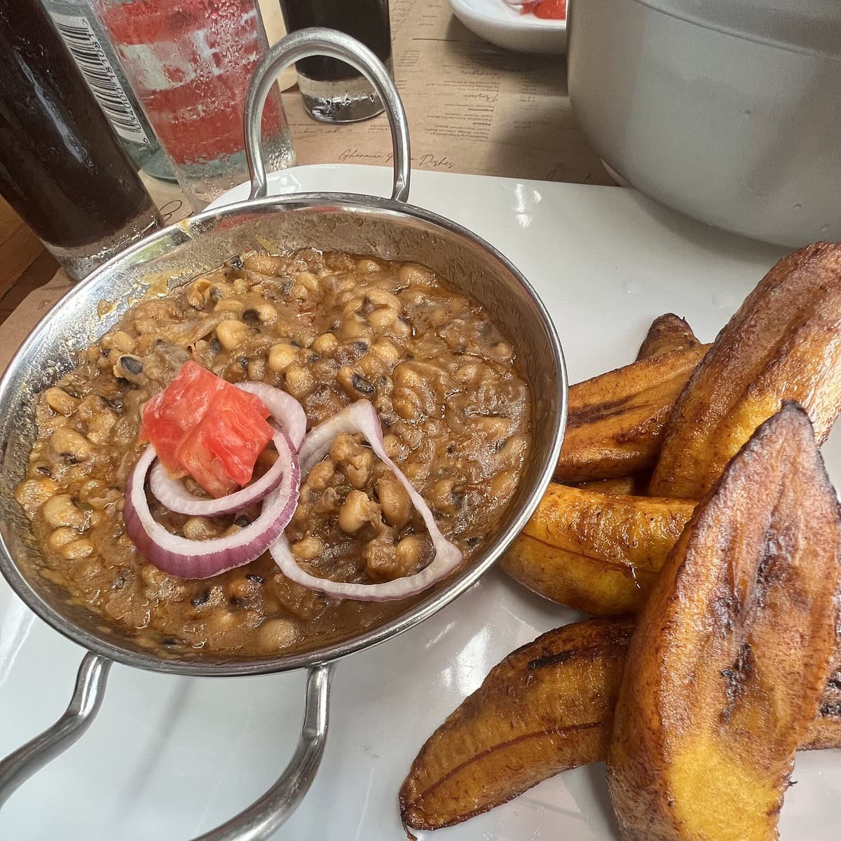 A bowl of Red-red with sweet plantains on the side.