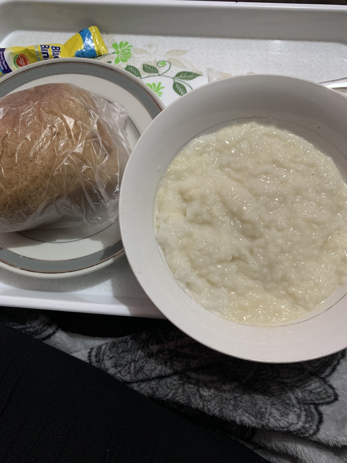 A bowl of rice water, a traditional Ghanaian breakfast in Ghana with a loaf of bread on the side. 