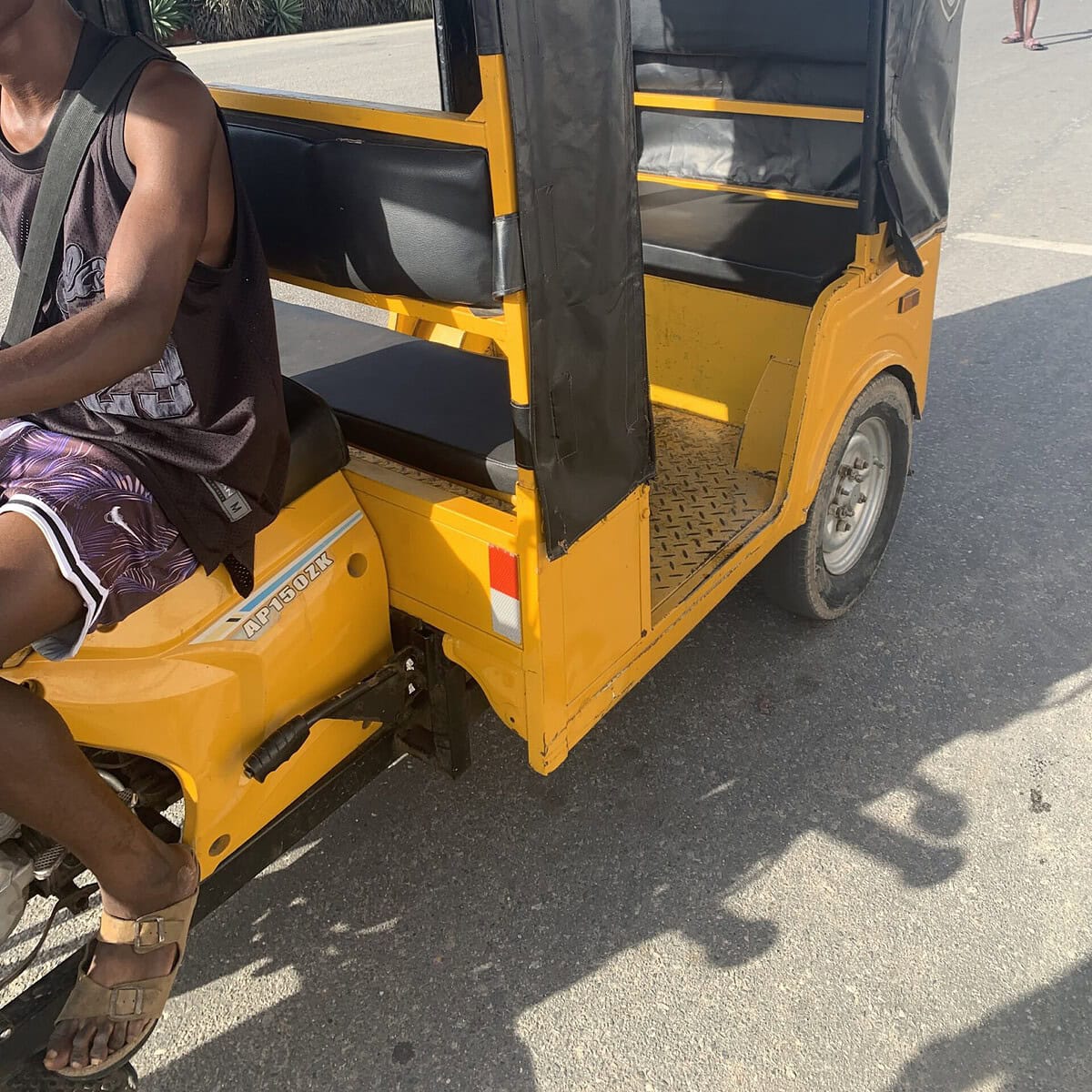 A yellow and black tuk tuk