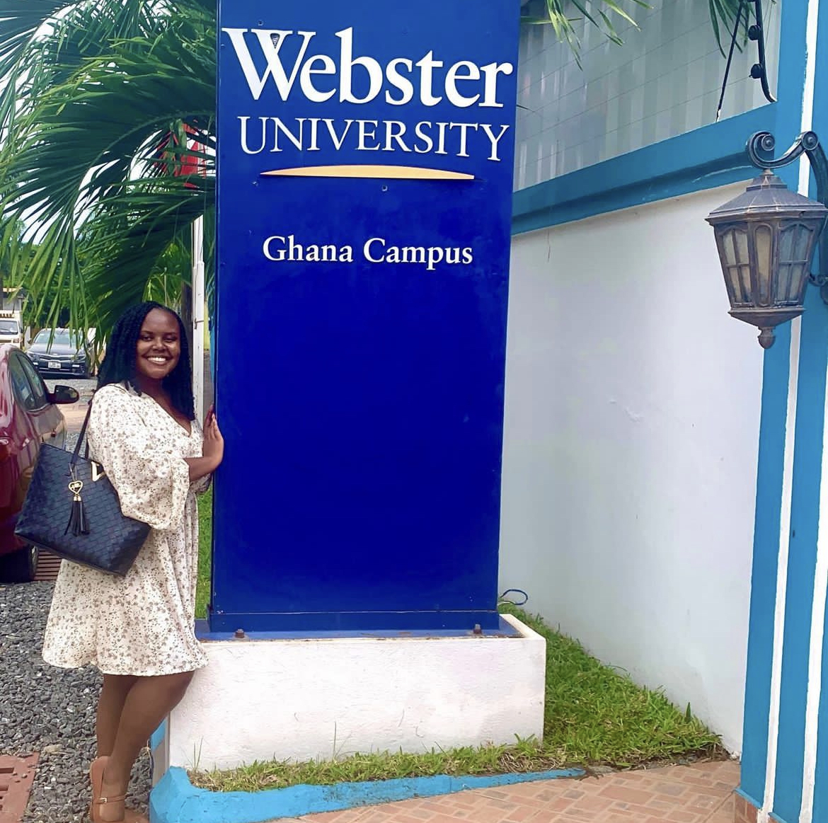 Christina Jane posing in front of the Webster University sign