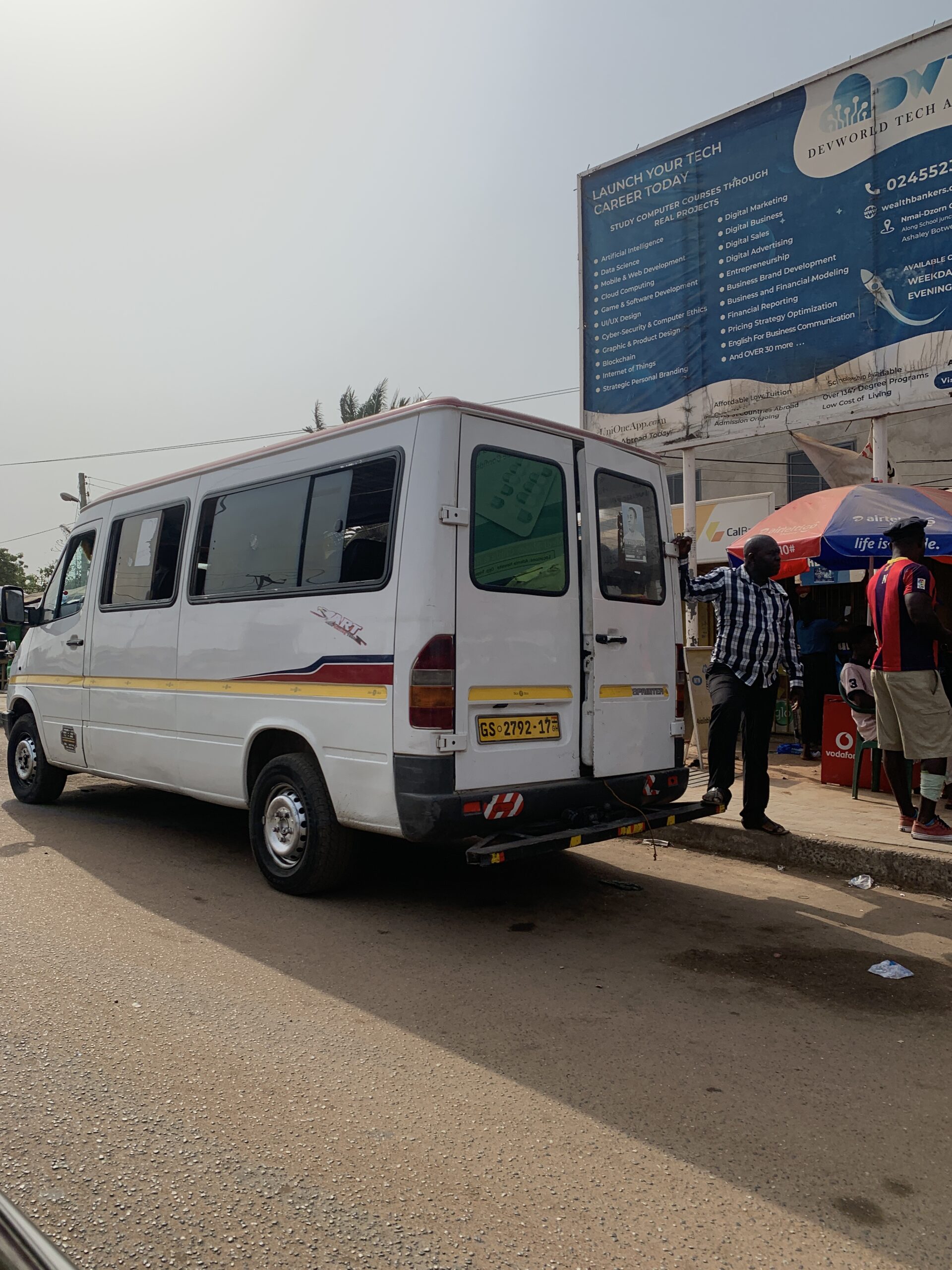 A white tro tro passing on the streets in Accra.