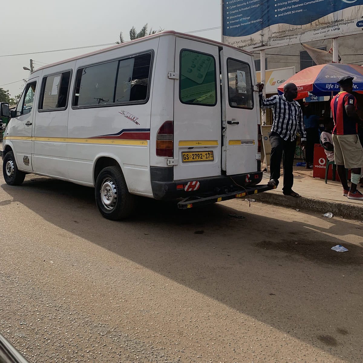 A white tro tro passing on the streets in Accra.