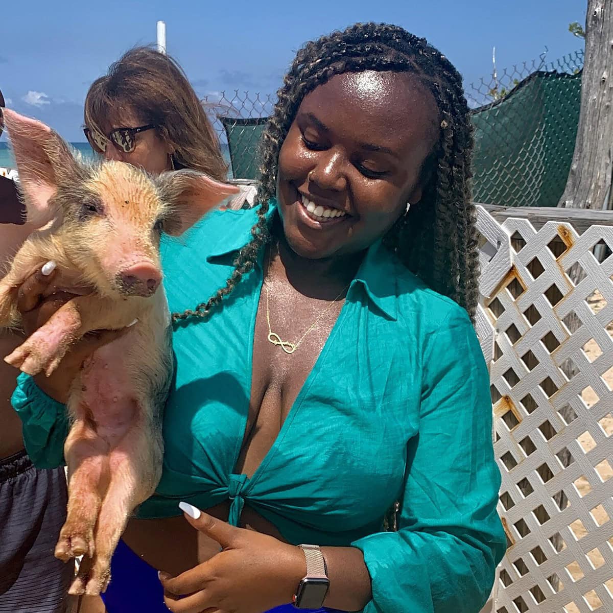 Blogger Christina Jane holding a pig in the Bahamas 