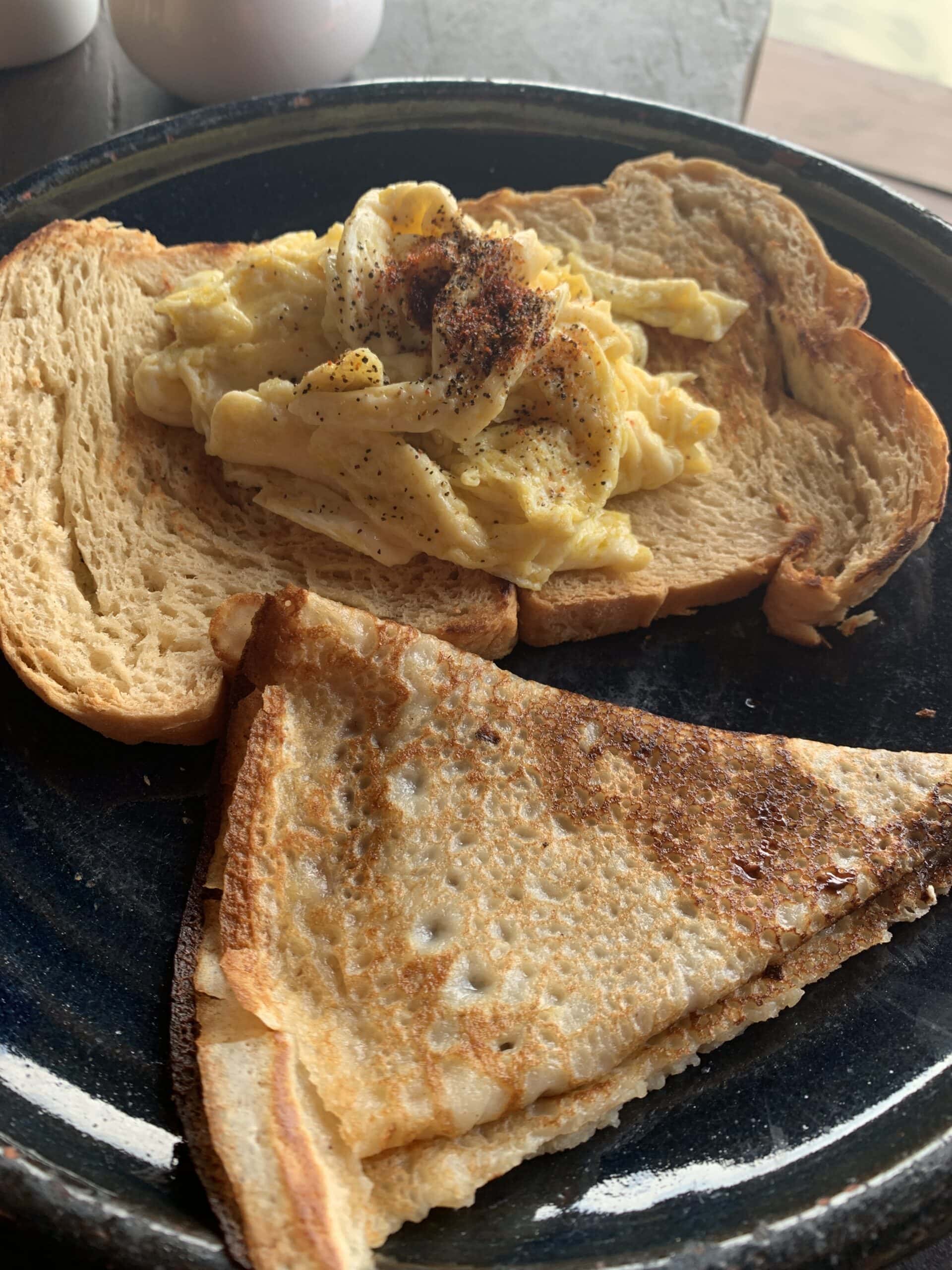 Chocolate pancake with eggs and toast
