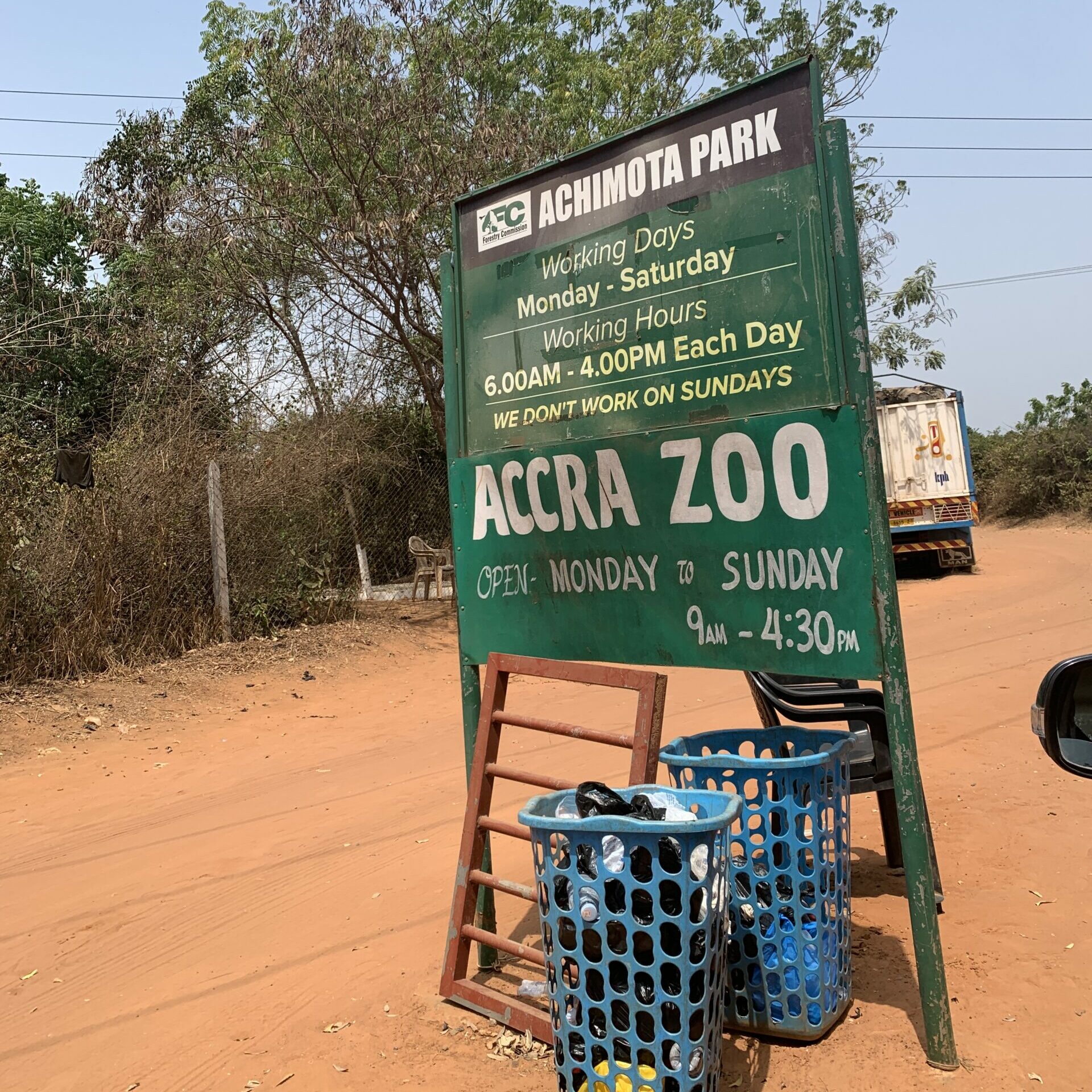 The welcoming sign at the entrance of the Accra Zoo that reads that it is open Mon - Sat from 6am-4pm. 