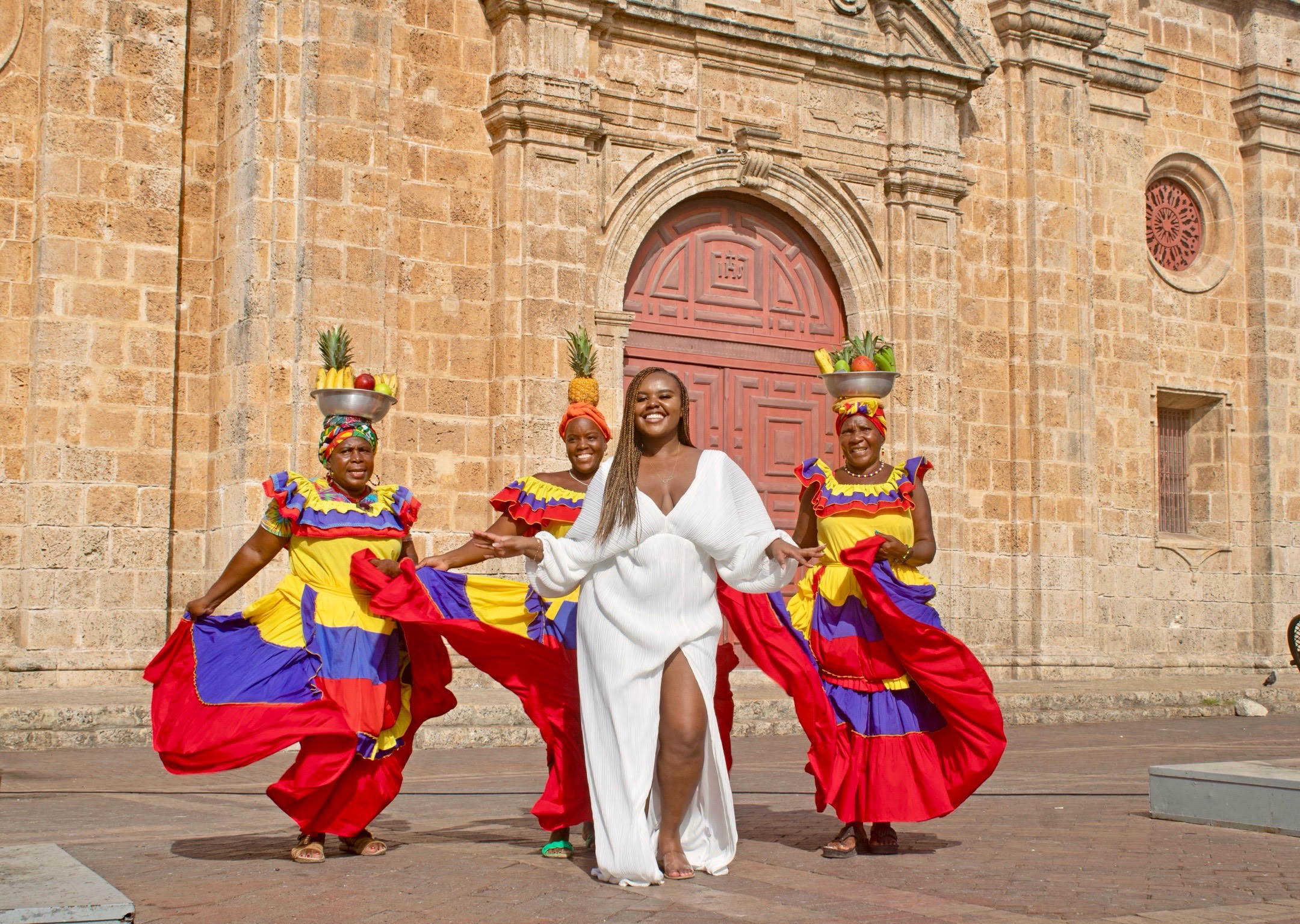 Christina Jane dancing with Palenqueras behind her