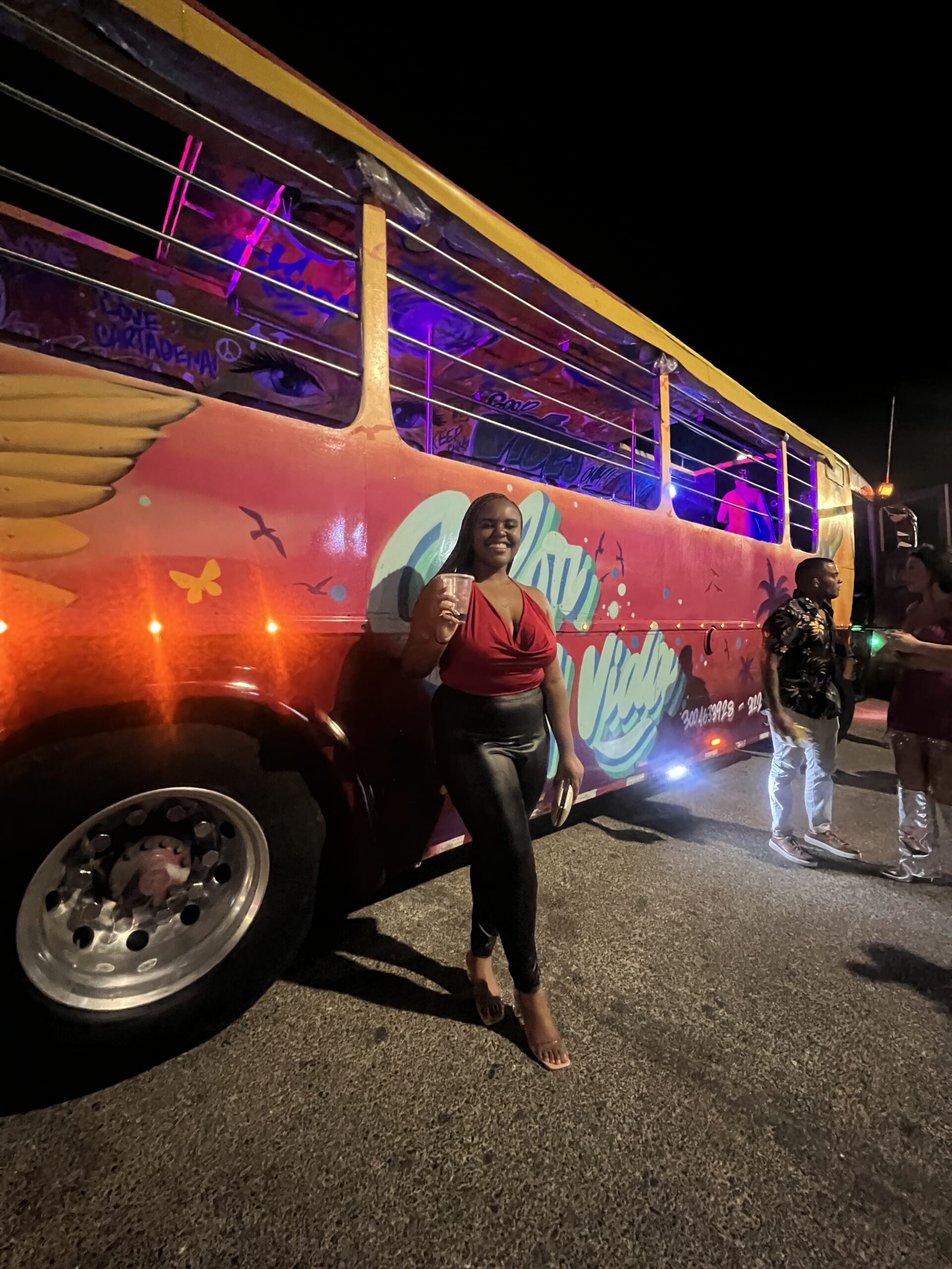 Christina Jane posing in front of a Chiva Party Bus 