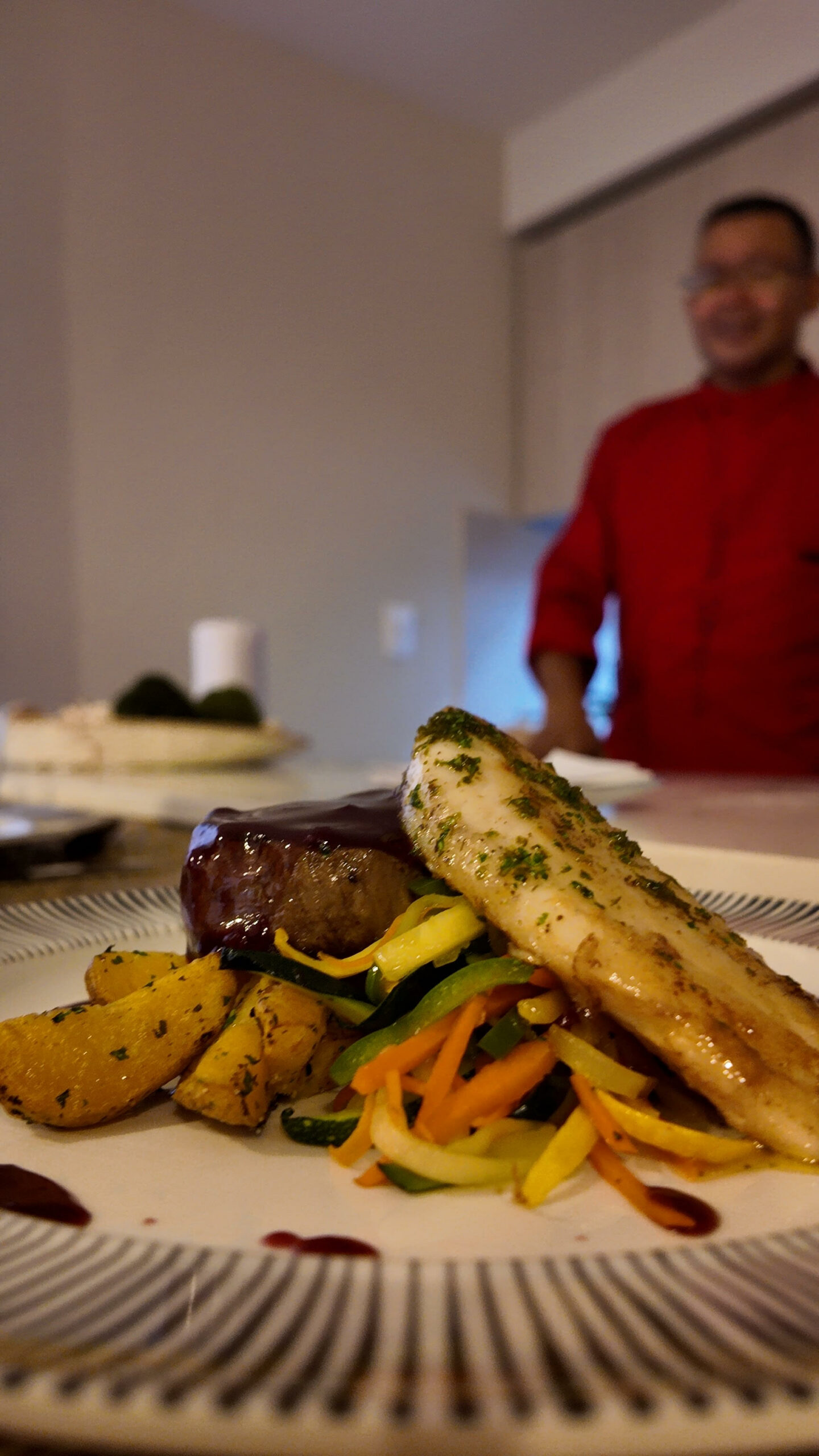 Beef tenderloin and fish with vegetables, lemon butter, and red wine sauce