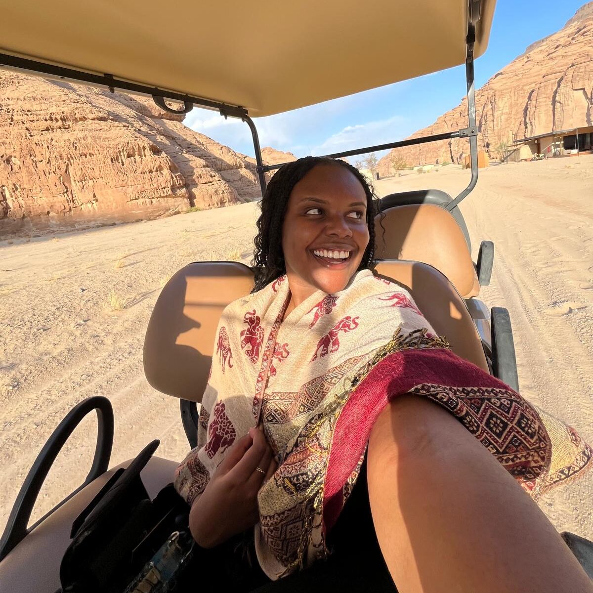 Christina Jane riding in a golf cart