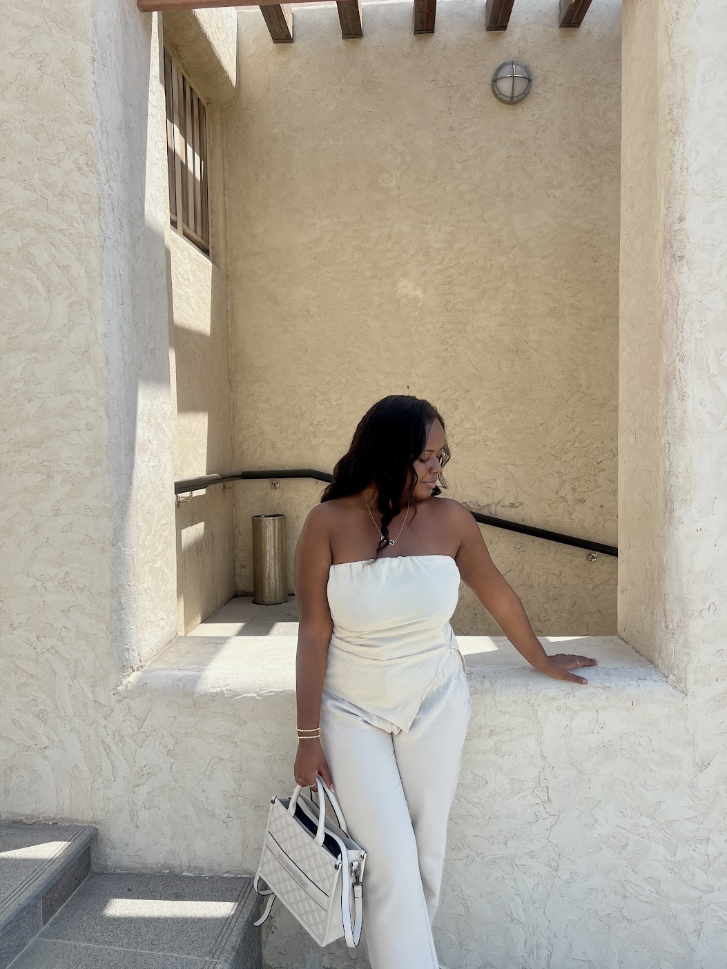 Christina wearing a strapless top and trousers