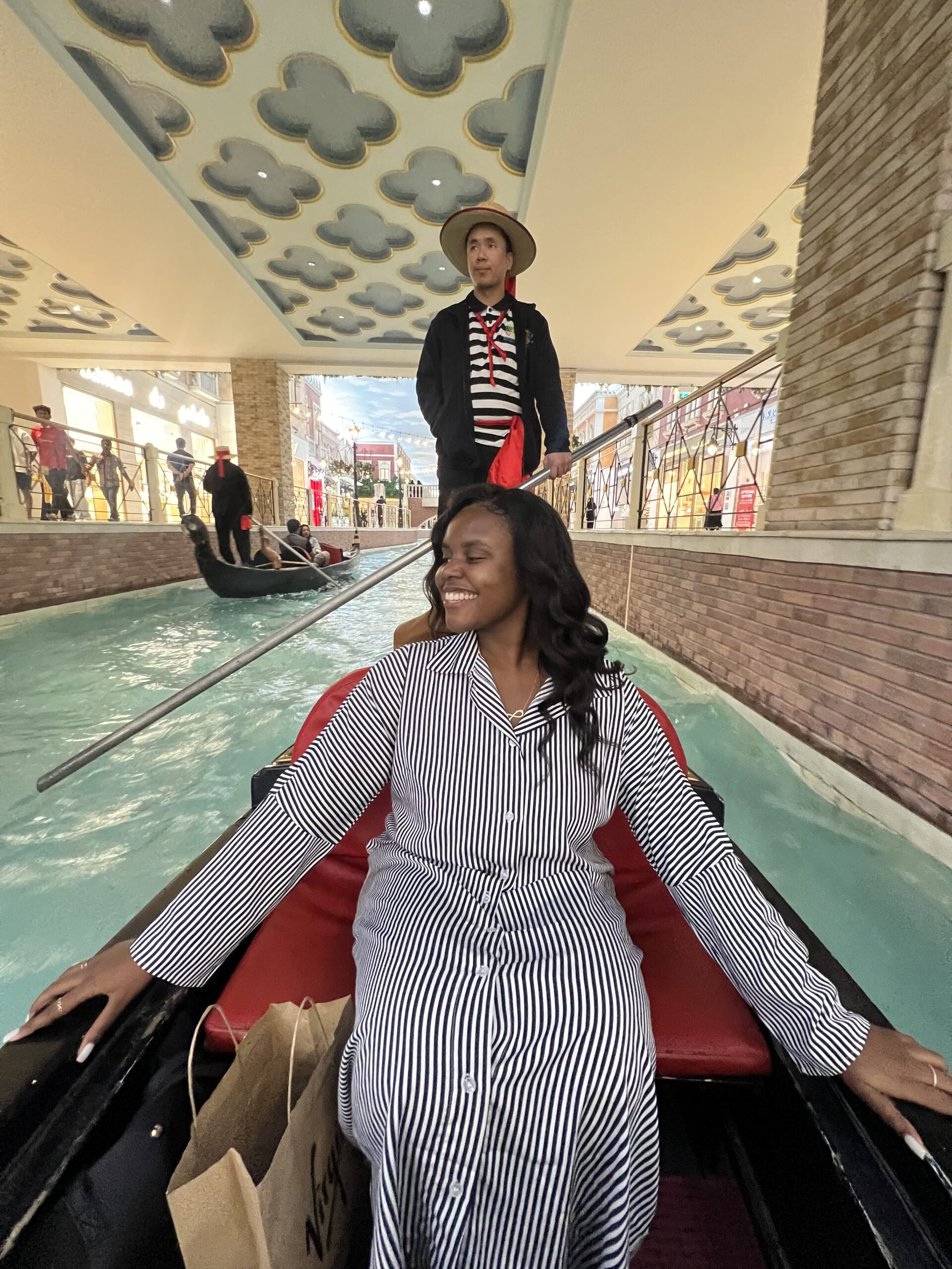 Christina taking a gondola ride in Villaggio Mall 