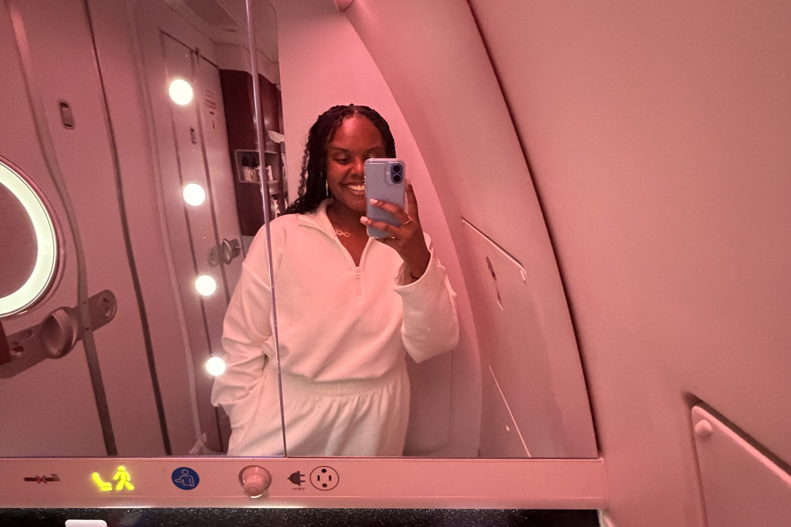 Christina Jane inside of the bathroom on a Qatar Airways flight