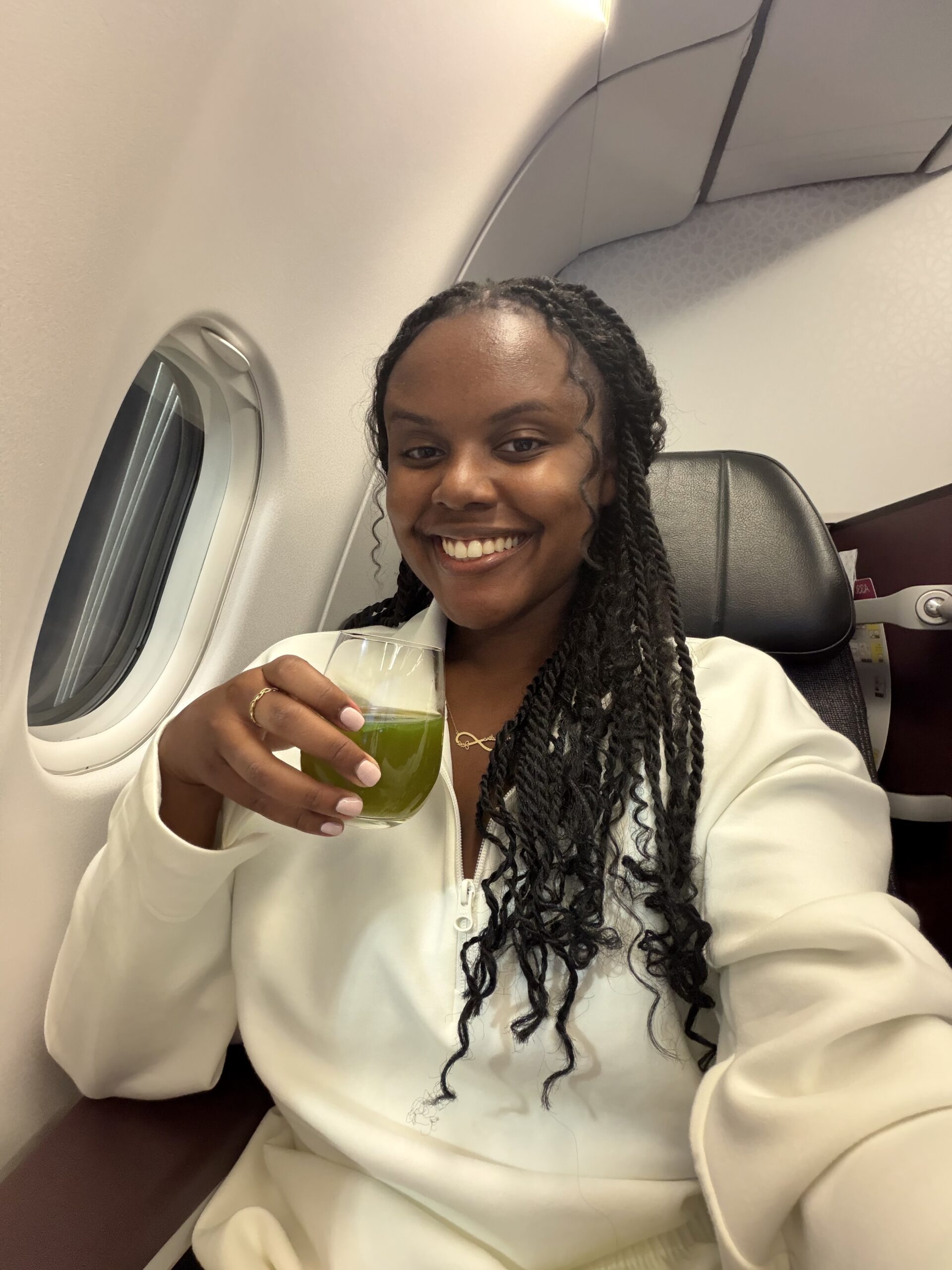 Christina holding a mint lemonade drink in-flight